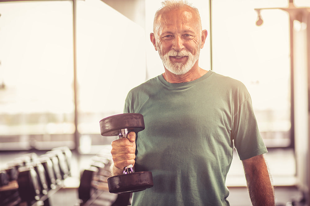 Healthy Senior man lifts weights